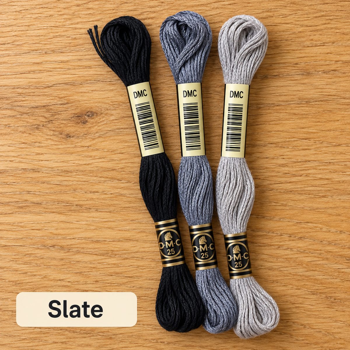 Slate palette: three DMC six-strand embroidery floss skeins